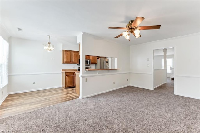 284 Windbrooke Ln, Virginia Beach, VA 23462 - unfurnished living room featuring light carpet, a chandelier, ceiling fan, and crown molding