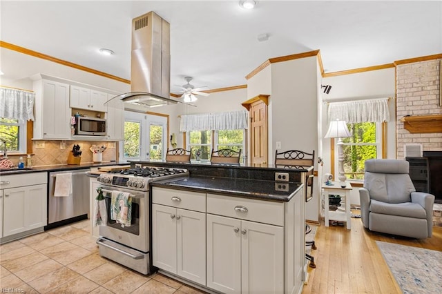 801 Kings Creek Dr, Virginia Beach, VA 23464 - kitchen with appliances with stainless steel finishes, island range hood, a ceiling fan, healthy amount of natural light, and crown molding