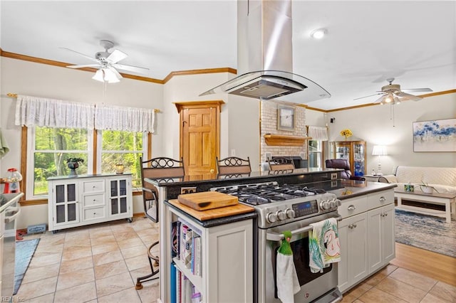 801 Kings Creek Dr, Virginia Beach, VA 23464 - kitchen with ceiling fan, gas stove, island exhaust hood, ornamental molding, and dark countertops