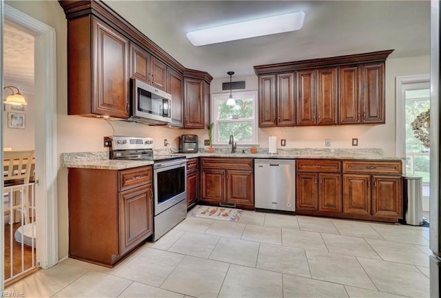 2816 Ashwood Dr, Chesapeake, VA 23321 - kitchen with stainless steel appliances, light stone counters, plenty of natural light, and pendant lighting