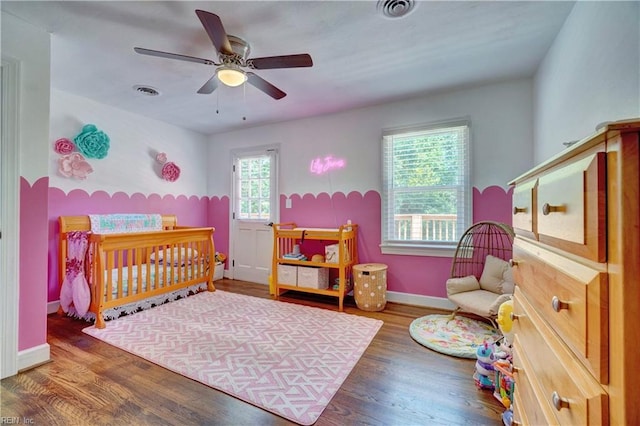 2816 Ashwood Dr, Chesapeake, VA 23321 - bedroom with wood finished floors, a ceiling fan, and a crib