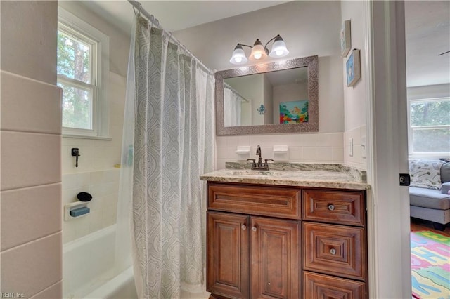2816 Ashwood Dr, Chesapeake, VA 23321 - bathroom featuring healthy amount of natural light, shower / bathtub combination with curtain, vanity, tile walls, and ensuite bath