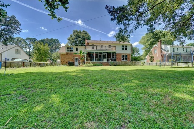 2816 Ashwood Dr, Chesapeake, VA 23321 - rear view of house with a trampoline, a sunroom, brick siding, and a fenced backyard