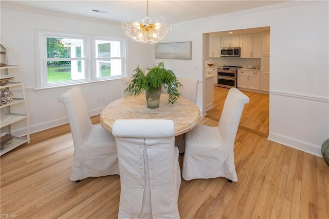 1009 Abingdon Rd, Virginia Beach, VA 23451 - dining space with a chandelier, crown molding, and light wood-type flooring