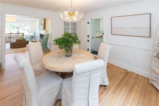 1009 Abingdon Rd, Virginia Beach, VA 23451 - dining area featuring a chandelier, crown molding, and light wood-style floors