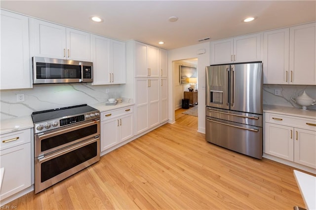 1009 Abingdon Rd, Virginia Beach, VA 23451 - kitchen with appliances with stainless steel finishes, light wood-type flooring, white cabinets, backsplash, and recessed lighting