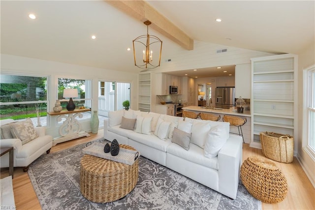 1009 Abingdon Rd, Virginia Beach, VA 23451 - living room with light wood-type flooring and a chandelier