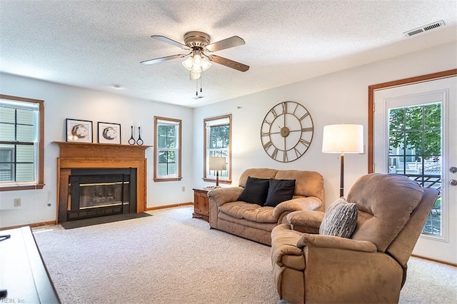 13 Fawn Cir, Hampton, VA 23666 - carpeted living area with ceiling fan, a textured ceiling, plenty of natural light, and a fireplace with flush hearth