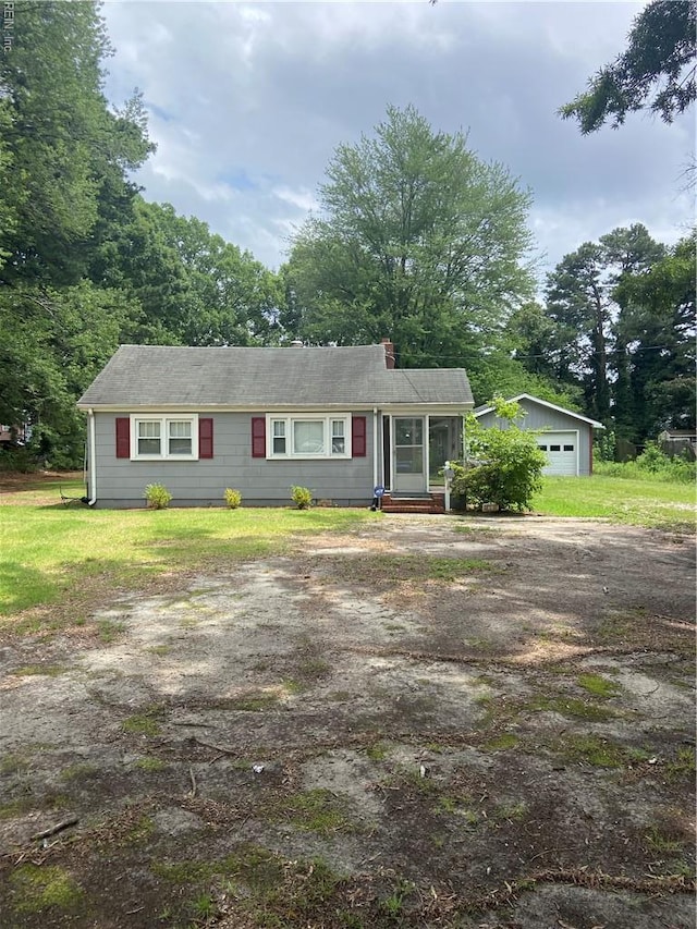 23 Forrest Dr, Newport News, VA 23606 - ranch-style home featuring dirt driveway, a garage, a chimney, and an outdoor structure