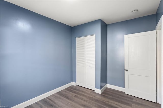3033 Williams St, Newport News, VA 23607 - unfurnished bedroom with dark wood-style floors and a closet