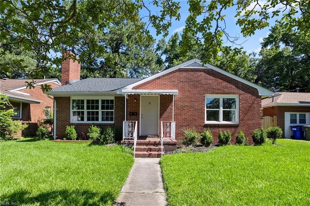 2822 Beachmont Ave, Norfolk, VA 23504 - view of front of house featuring a chimney, brick siding, and a front lawn