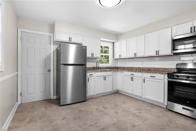 2822 Beachmont Ave, Norfolk, VA 23504 - kitchen with stainless steel appliances, white cabinets, backsplash, and dark stone counters