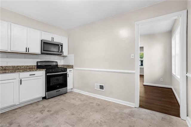 2822 Beachmont Ave, Norfolk, VA 23504 - kitchen with gas stove, stainless steel microwave, white cabinets, and backsplash