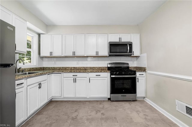 2822 Beachmont Ave, Norfolk, VA 23504 - kitchen featuring appliances with stainless steel finishes, white cabinets, and dark stone countertops