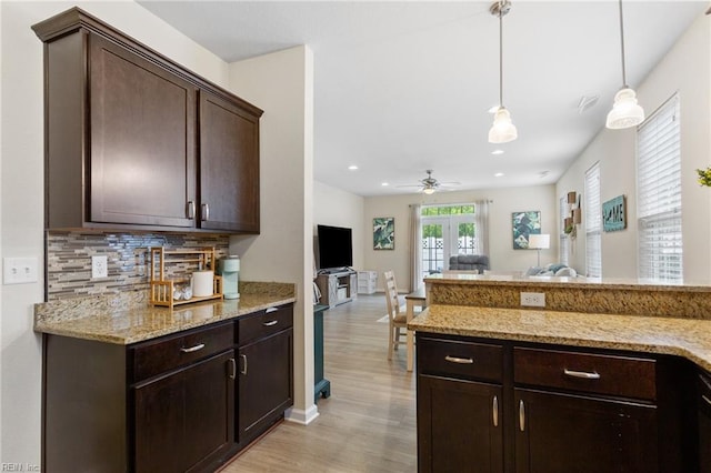 2816 Gavin Rd Unit 14, Chesapeake, VA 23323 - kitchen featuring dark brown cabinets, light wood-style floors, tasteful backsplash, hanging light fixtures, and open floor plan