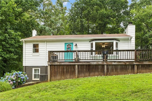 682 Bay Port Rd, Jamaica, VA 23079 - back of property with a chimney, a deck, and a lawn