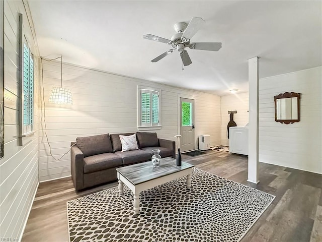 682 Bay Port Rd, Jamaica, VA 23079 - living room with wood finished floors, washer / dryer, ceiling fan, and wood walls