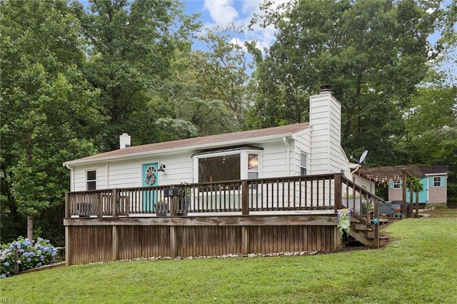 682 Bay Port Rd, Jamaica, VA 23079 - back of property featuring a chimney, a deck, a lawn, and view of scattered trees