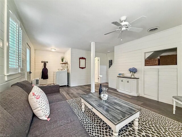 682 Bay Port Rd, Jamaica, VA 23079 - living area featuring washer / dryer, wood finished floors, a ceiling fan, and wooden walls