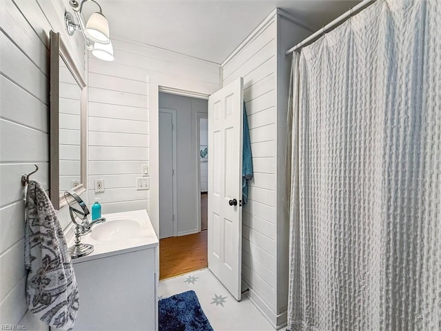 682 Bay Port Rd, Jamaica, VA 23079 - bathroom featuring vanity, a shower with shower curtain, and wood walls