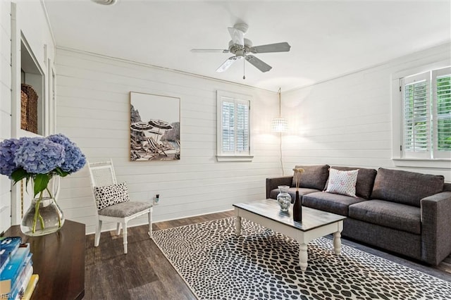 682 Bay Port Rd, Jamaica, VA 23079 - living area featuring healthy amount of natural light, dark wood finished floors, ceiling fan, and wood walls