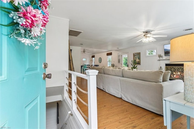 682 Bay Port Rd, Jamaica, VA 23079 - living room featuring ceiling fan, wood finished floors, and a fireplace