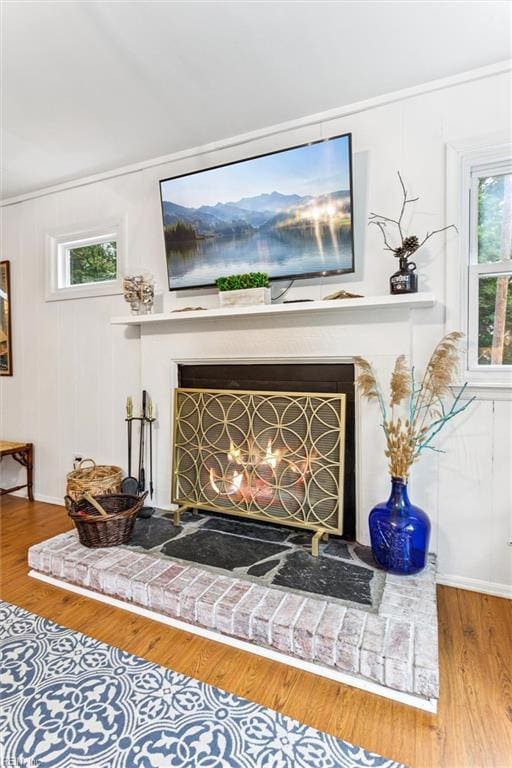 682 Bay Port Rd, Jamaica, VA 23079 - detailed view of a brick fireplace, wood finished floors, and crown molding