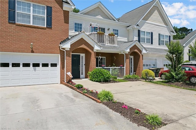 903 Rustads Cir, Williamsburg, VA 23188 - view of front of home featuring brick siding, covered porch, concrete driveway, and a balcony