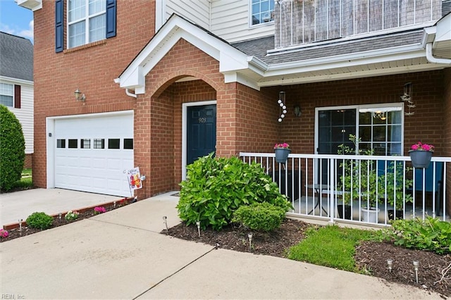 903 Rustads Cir, Williamsburg, VA 23188 - property entrance featuring a garage, brick siding, a porch, driveway, and a shingled roof