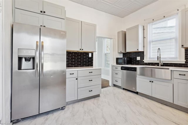1145 24th St, Newport News, VA 23607 - kitchen featuring appliances with stainless steel finishes, backsplash, light marble finish floors, light countertops, and gray cabinets