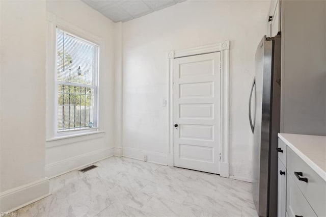 1145 24th St, Newport News, VA 23607 - unfurnished dining area with light marble finish floors and baseboards