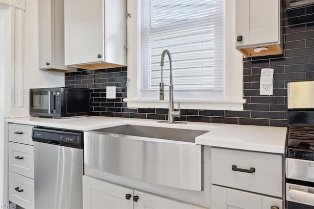 1145 24th St, Newport News, VA 23607 - kitchen with stainless steel appliances, decorative backsplash, white cabinets, and healthy amount of natural light