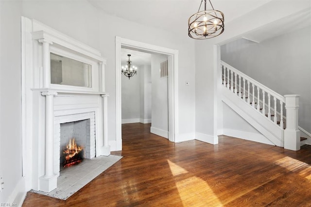 1145 24th St, Newport News, VA 23607 - unfurnished living room featuring a chandelier, wood finished floors, and stairway
