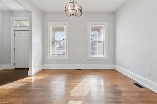 1145 24th St, Newport News, VA 23607 - unfurnished dining area with a chandelier and wood finished floors