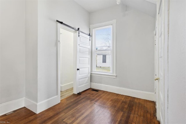 1145 24th St, Newport News, VA 23607 - unfurnished bedroom featuring a barn door, hardwood / wood-style flooring, and multiple windows