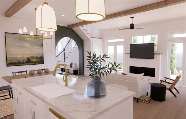 203 Hodges Rd, Chesapeake, VA 23322 - kitchen with beamed ceiling, a ceiling fan, white cabinets, a fireplace, and light stone countertops