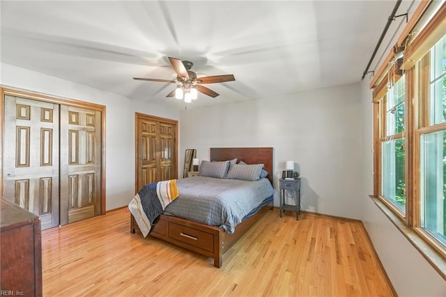 1628 Hawks Bill Dr, Virginia Beach, VA 23464 - bedroom with light wood-style floors, multiple windows, two closets, and a ceiling fan