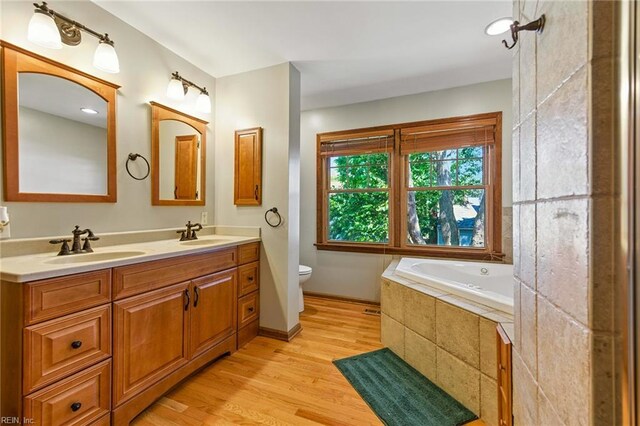 1628 Hawks Bill Dr, Virginia Beach, VA 23464 - bathroom with double vanity, wood finished floors, and a bath