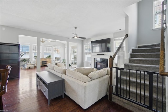2137 Bellflower Way, Chesapeake, VA 23323 - living area featuring a glass covered fireplace, a ceiling fan, dark wood-style floors, and stairs