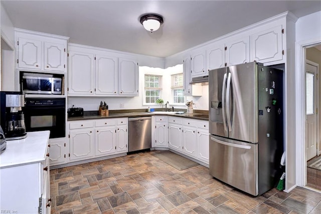 112 Archer Rd, Newport News, VA 23606 - kitchen with appliances with stainless steel finishes, white cabinets, stone finish floors, and dark countertops