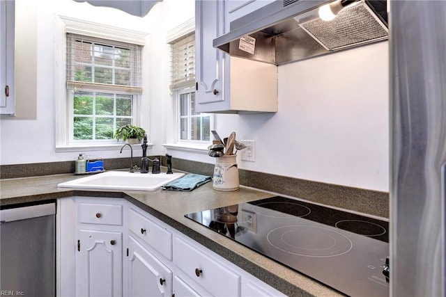 112 Archer Rd, Newport News, VA 23606 - kitchen with black electric cooktop, dishwasher, premium range hood, dark countertops, and white cabinetry