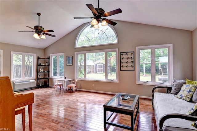 112 Archer Rd, Newport News, VA 23606 - living room featuring a ceiling fan, a wall unit AC, wood finished floors, and high vaulted ceiling