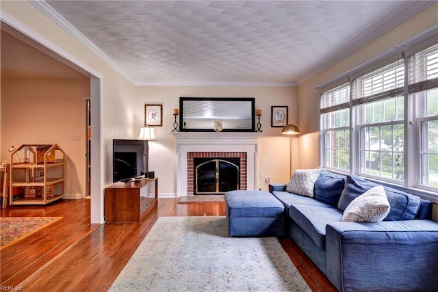 112 Archer Rd, Newport News, VA 23606 - living area with a brick fireplace, wood finished floors, ornamental molding, and a textured ceiling