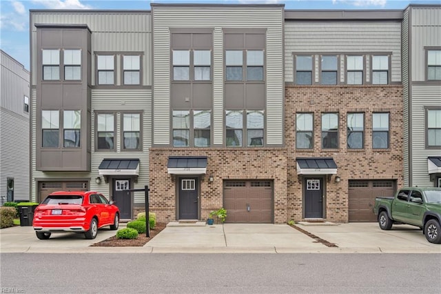 1728 Shorebird Ln, Virginia Beach, VA 23456 - townhome / multi-family property featuring brick siding, a garage, and driveway