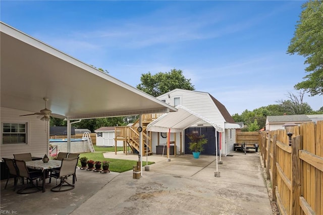 12 Sylvia Ln, Newport News, VA 23602 - fenced backyard with a storage unit, a patio area, outdoor dining area, stairway, and ceiling fan
