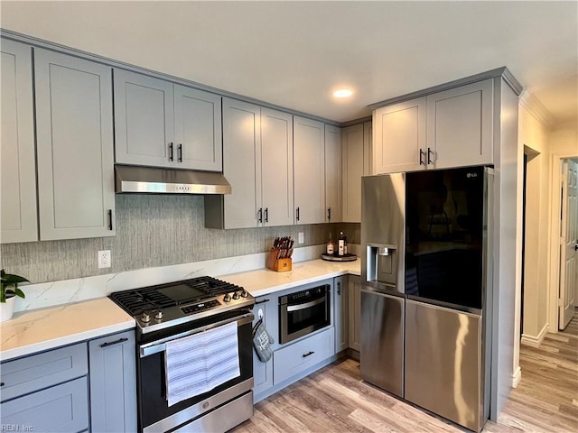 120 Lancelot Dr, Suffolk, VA 23434 - kitchen with stainless steel appliances, under cabinet range hood, gray cabinets, light wood-type flooring, and ornamental molding