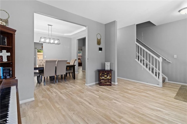 3904 River Breeze Cir, Chesapeake, VA 23321 - interior space with stairs, light wood-style floors, a chandelier, and a raised ceiling