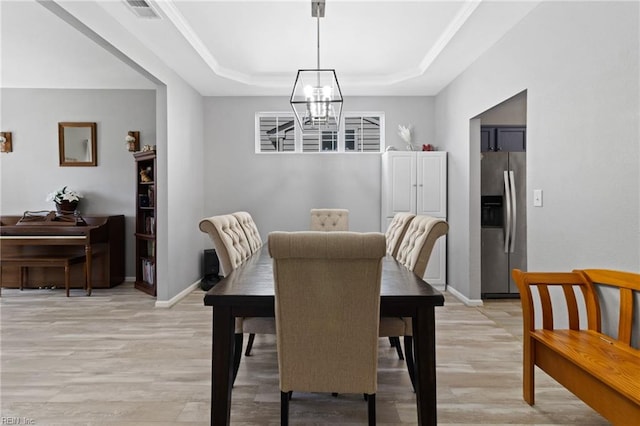 3904 River Breeze Cir, Chesapeake, VA 23321 - dining space featuring a chandelier, a tray ceiling, light wood-style flooring, and crown molding