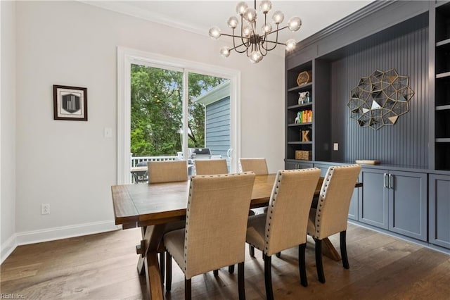 104 Tucker Ct, Carrollton, VA 23314 - dining room featuring crown molding, built in features, a chandelier, and wood finished floors
