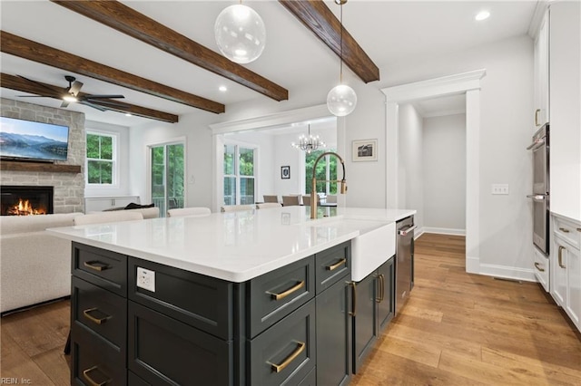 104 Tucker Ct, Carrollton, VA 23314 - kitchen featuring light wood-style flooring, a fireplace, white cabinets, light countertops, and recessed lighting